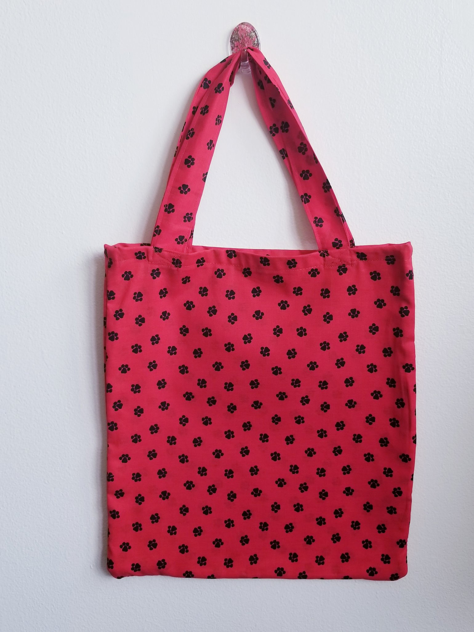 Image of Red tote bag with black paw prints