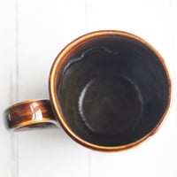 Image 9 of Amber Brown, and Matte Black Pottery Mug, 12 oz. Handcrafted Coffee Cup, Made in USA