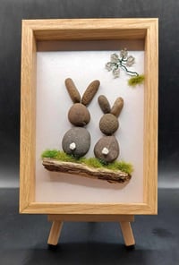 PEBBLE BUNNIES ON LOG IN WOODLAND SCENE