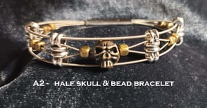 Image of  Half Skull and Bead Guitar String Bracelet