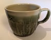 Hand throw, stoneware mug with carved green glaze.