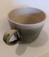 Hand thrown, stoneware mug with spotted green glaze. Image 2