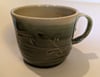 Hand thrown, stoneware mug with carved green glaze