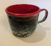 Hand thrown, stoneware mug, with speckled red, blue, purple glaze with red interior