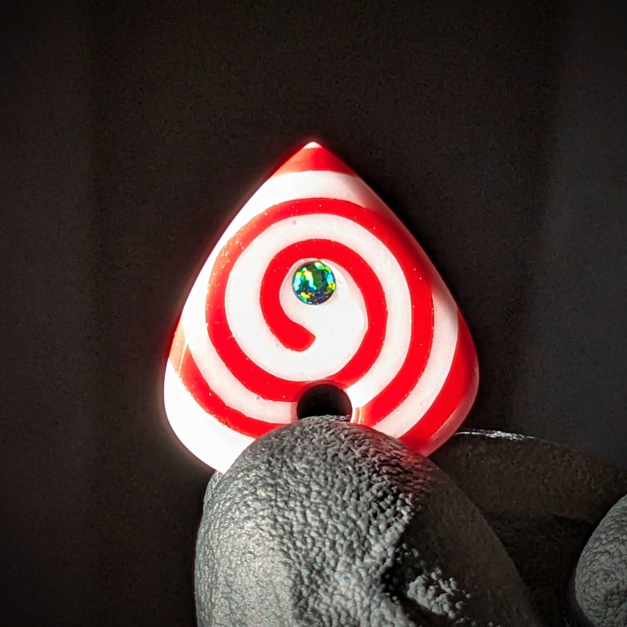 Image of Red and White Spiral Glass Guitar Pick Pendant 