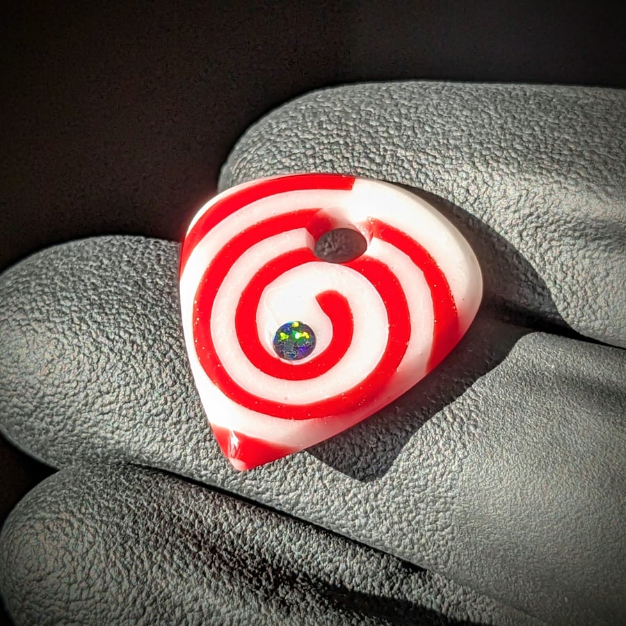 Image of Red and White Spiral Glass Guitar Pick Pendant 