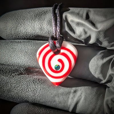 Image of Red and White Spiral Glass Guitar Pick Pendant 