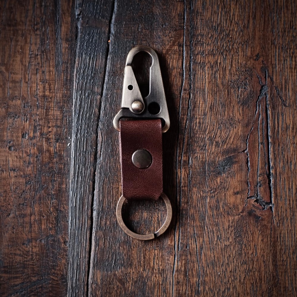 Image of Old Dutch Snap Trigger Key Chain. (Dark brown).