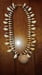 Image of SUNDIAL SHELL W/DOUBLE STRAND MINIATURE SHELLS, COWRIES AND COPPER HEMATITE BEADS 