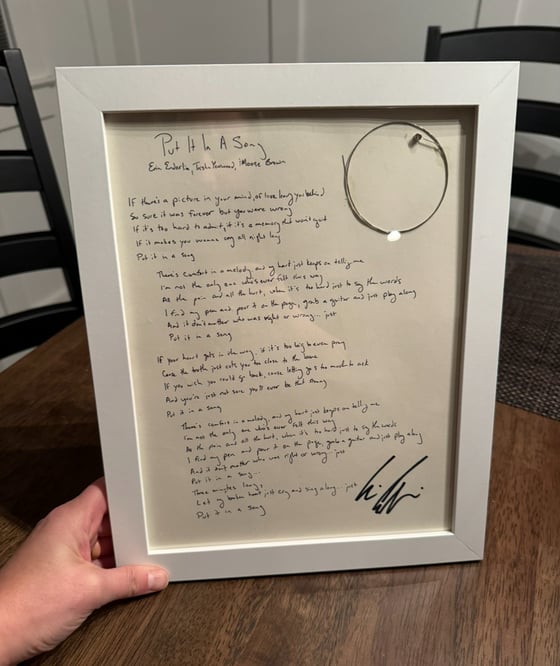 Image of Put It In A Song framed handwritten lyric with CMT guitar string