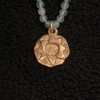 Image 1 of Bronze Sun pendant on a string of aquamarine.