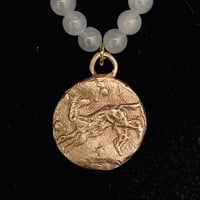 Image 1 of Bronze wolf pendant on a string of white jade.