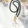 Black crystal laureate with baroque pearl pendant 