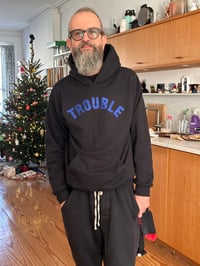 Image 1 of NEW Trouble Hoodie 🖤💙Black and Dark Blue Glitter