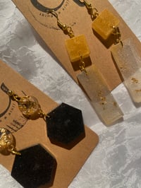 Image 1 of earrings with golden/silver flakes