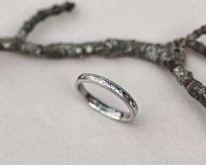 Image of  Platinum 3mm,  Latin engraved milled edge ring