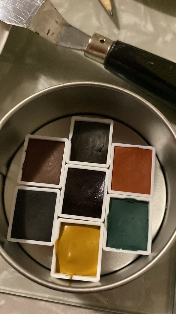 Image of 7 half pans of watercolor in a tin