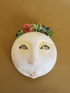 Wall mask with floral wreath