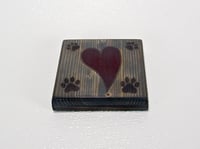 Image 1 of One wooden dog lover coaster with paw prints and a carved heart filled with red epoxy