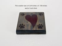 Image 2 of One wooden dog lover coaster with paw prints and a carved heart filled with red epoxy