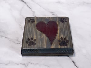 Image of One wooden dog lover coaster with paw prints and a carved heart filled with red epoxy