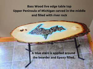Image of Handmande Live Edge Bass Wood Table Upper Peninsula of Michigan filled with river pebbles, epoxy