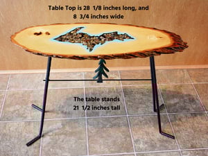 Image of Handmande Live Edge Bass Wood Table Upper Peninsula of Michigan filled with river pebbles, epoxy