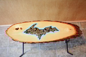 Image of Handmande Life Edge Bass Wood Table Upper Peninsula of Michigan filled with river pebbles, epoxy