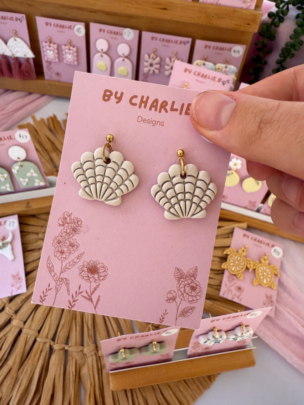Image of beige clam shell dangles