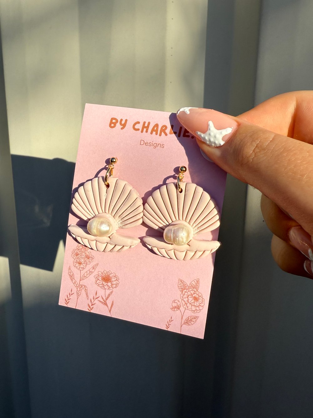 Image of pink clam shell dangles 