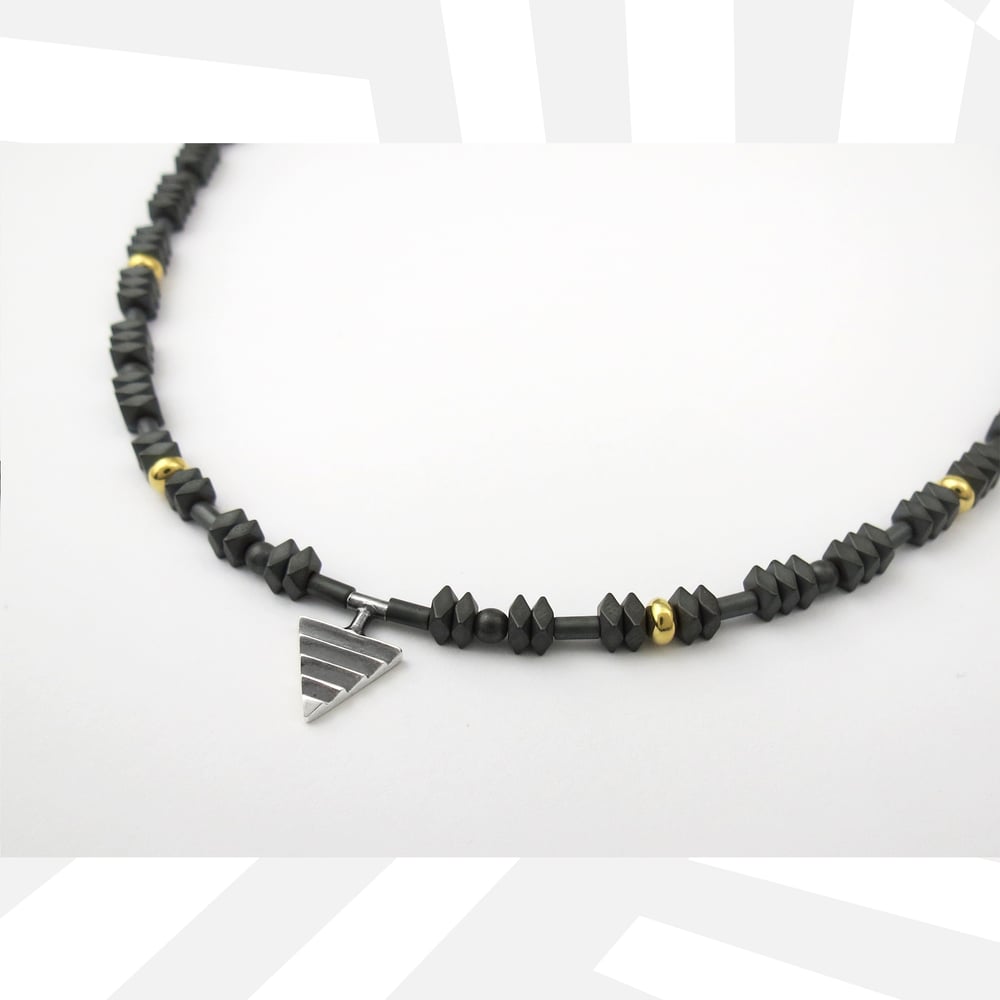 Image of Mono Delta on Hematite and Rolled Gold Beads