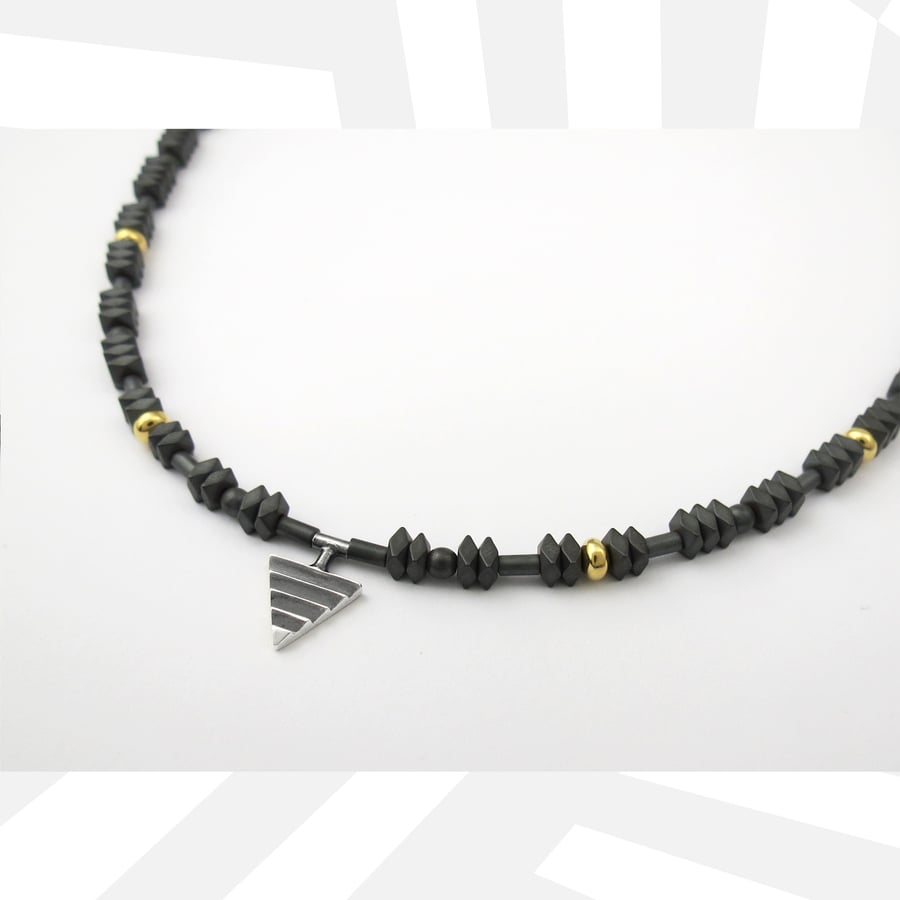 Image of Mono Delta on Hematite and Rolled Gold Beads