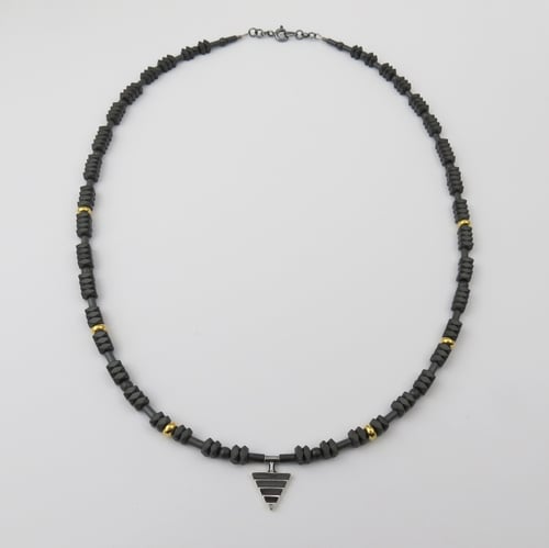 Image of Mono Delta on Hematite and Rolled Gold Beads