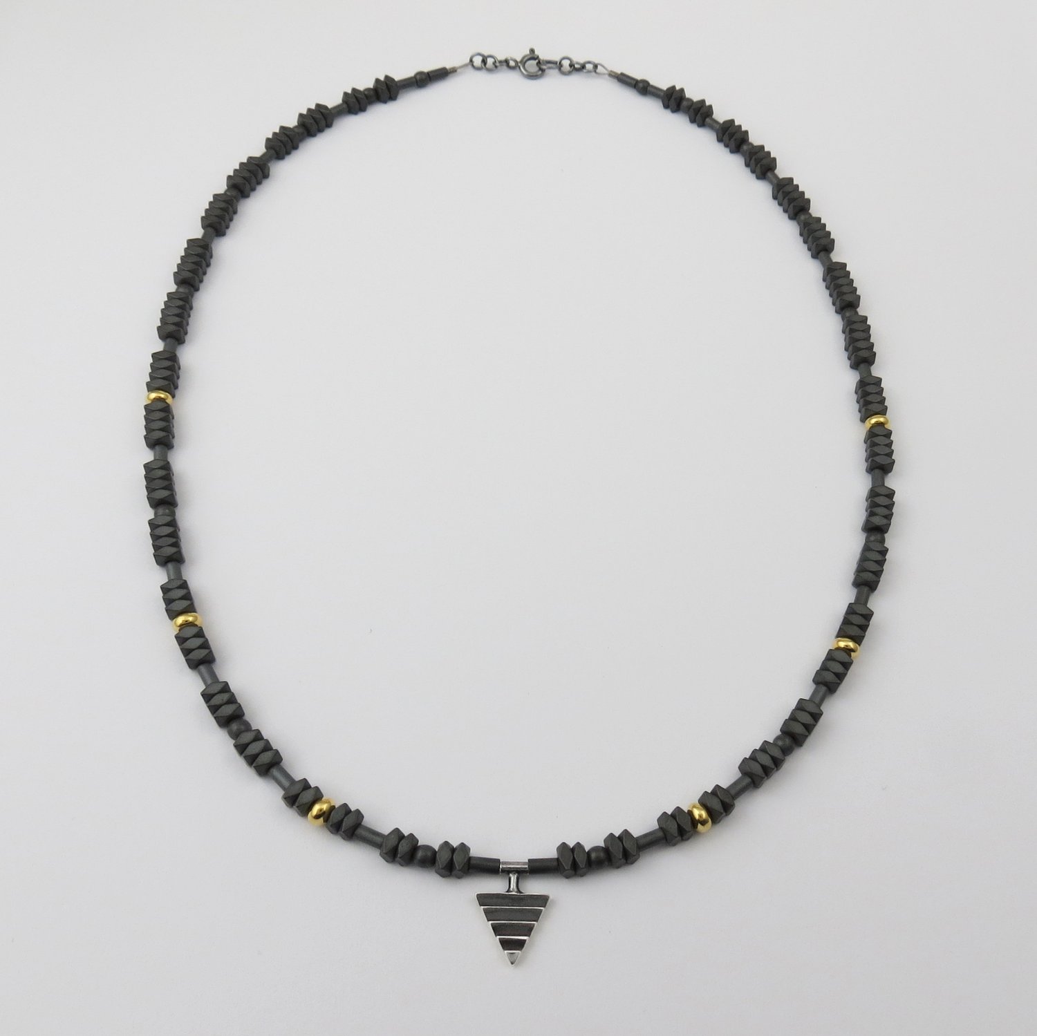 Image of Mono Delta on Hematite and Rolled Gold Beads