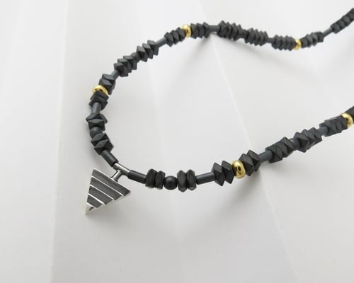 Image of Mono Delta on Hematite and Rolled Gold Beads