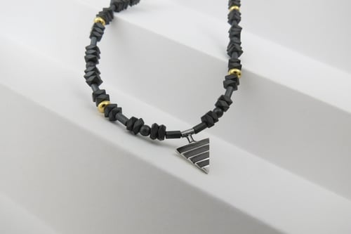 Image of Mono Delta on Hematite and Rolled Gold Beads