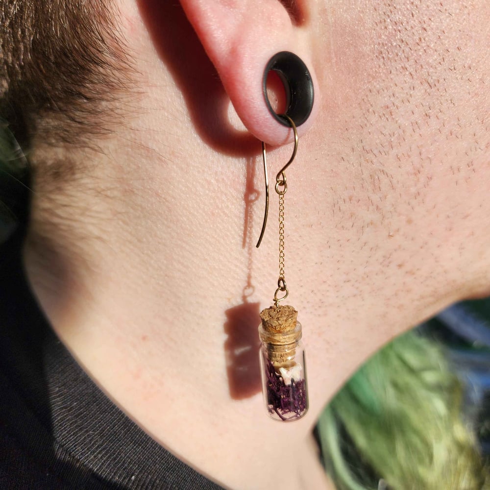 Image of mossy raccoon teeth earrings