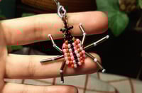 pink-red weevil charm