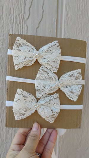 Image of Off white lace bows