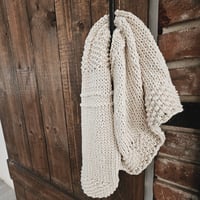 Image 1 of Amber hand knit cotton towel, made with recycled Argentinian cotton yarn. Handy corner loop to hang