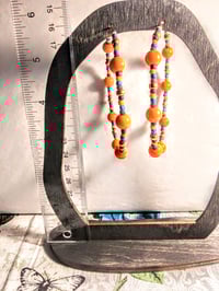Image 5 of Daisy Orange, Ocean Blue, Red, and Gold Multicolor Beaded Extra Large Hoop Earrings