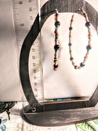 Image 5 of Petunia Black, Sky Blue, Ocean Blue, Orange, and Gold Multicolor Beaded Extra Large Hoop Earrings