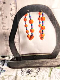 Image 5 of Daisy Orange, Sapphire Blue, Ocean Blue, and Red Multicolor Beaded Medium Hoop Earrings