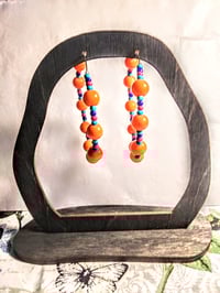 Image 6 of Daisy Orange, Sapphire Blue, Ocean Blue, and Red Multicolor Beaded Medium Hoop Earrings