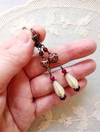 Image 2 of Renaissance copper filigree hearts long earrings handmade with red faceted & ivory glass pearl beads
