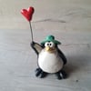 Balloon and green hat penguin. 