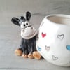 Donkey wonky pot with rainbow hearts.