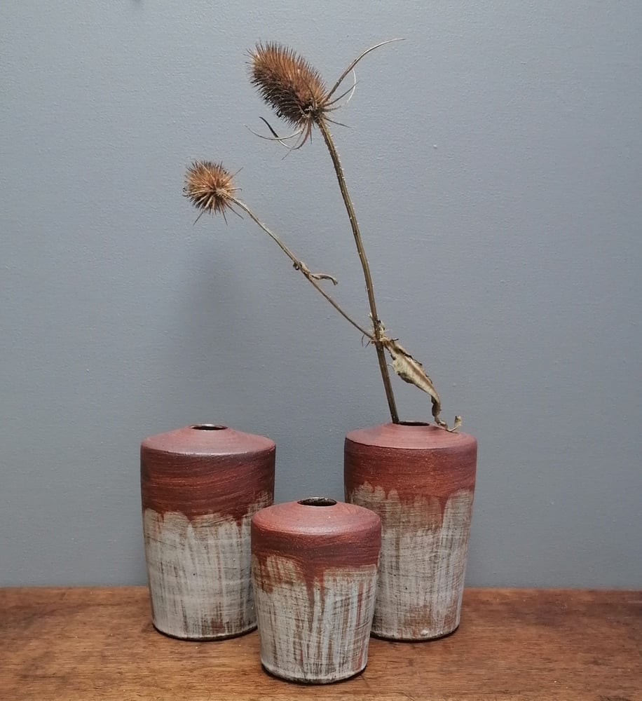 Image of Red clay bisque slipped trio of Vases.