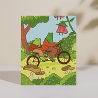 Image 1 of Frogs Riding a Bike