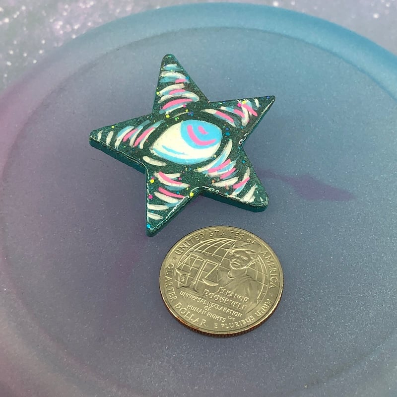 Image of Iridescent Green, Blue, Pink, and White Eyeball Star Pin